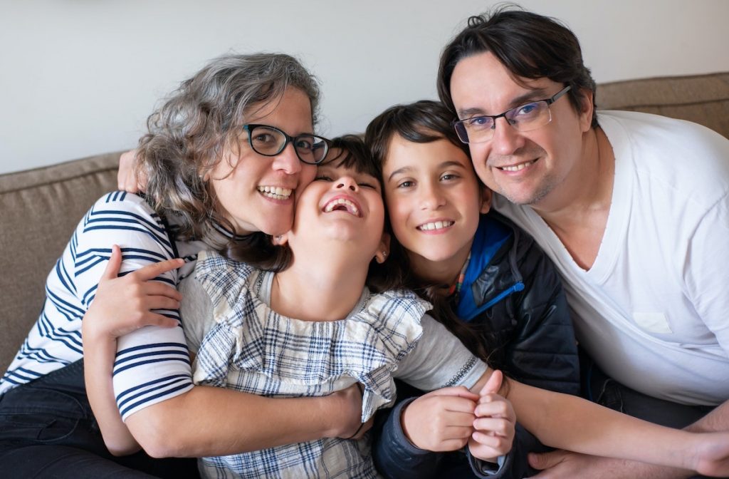Family in the Autism community bonding and embracing on a couch. 